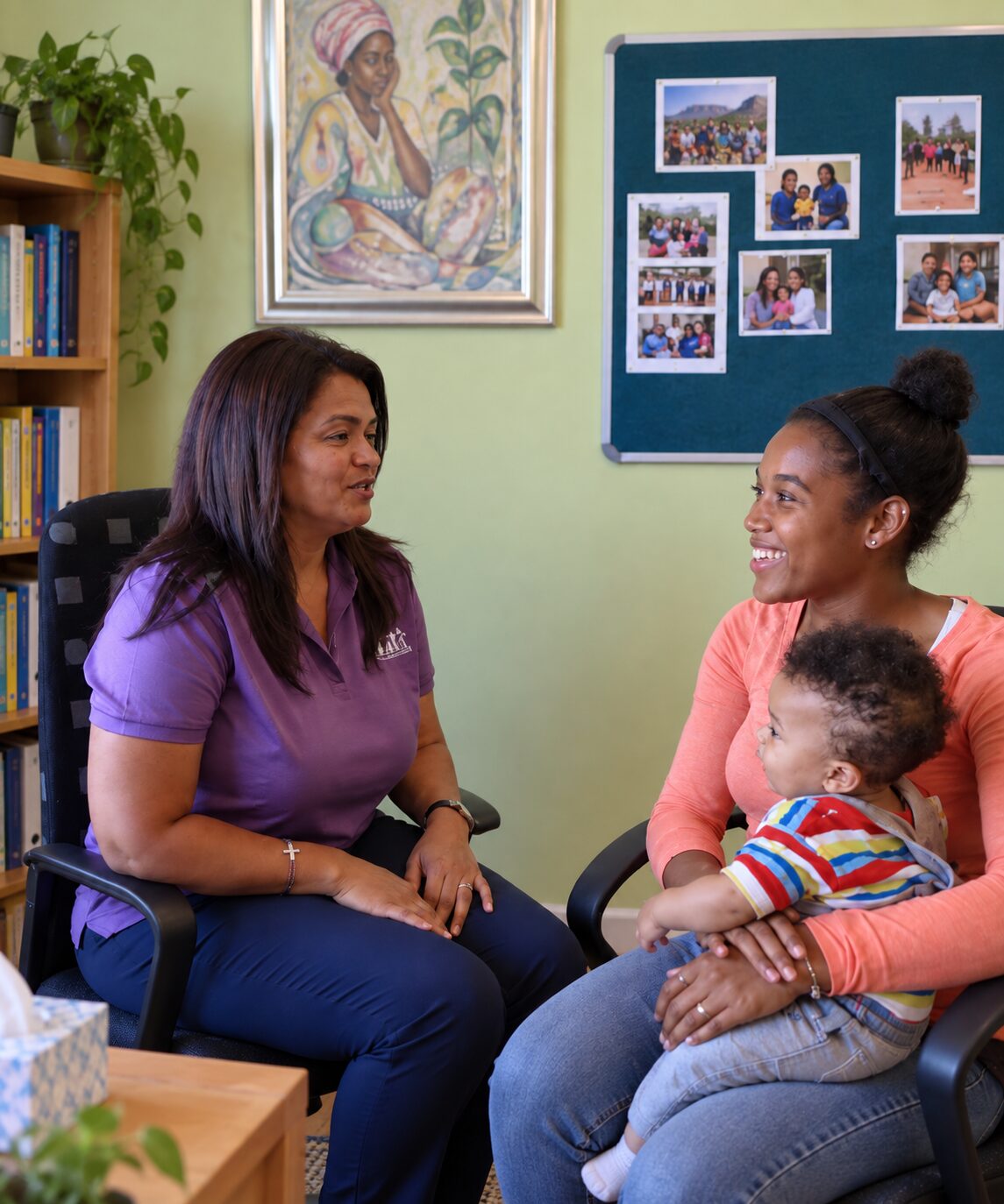 Counseling supervisor speaking with a mother holding her baby during a community-based support session in Cape Town.